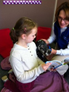 Reading Buddy Lily listens to first grader read.