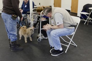 Oscar practices interacting with a row of patients