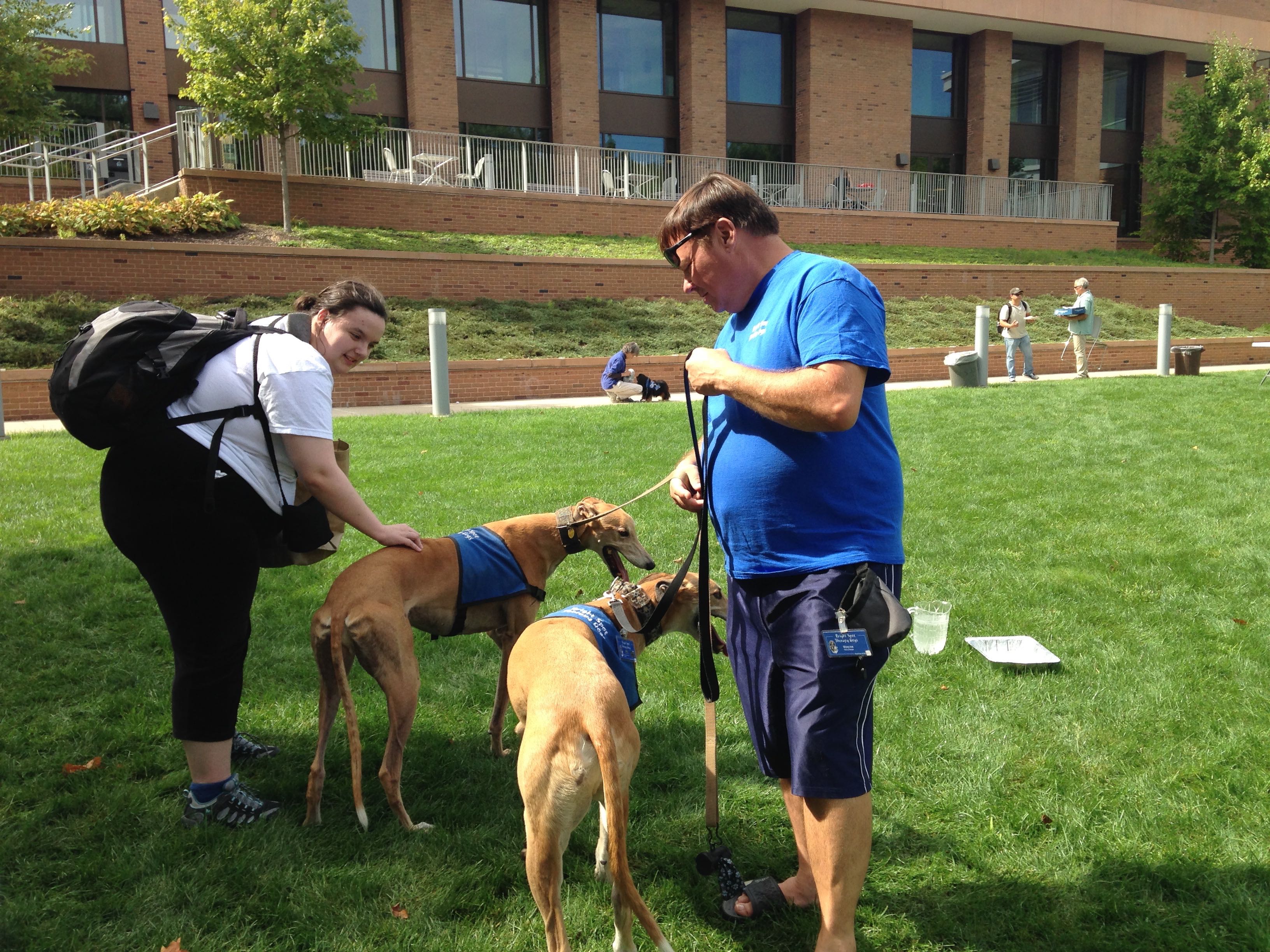 Bright Spot volunteer Wayne Desroches brings both of his Greyhounds Milo and Max, former racers turned therapy dogs. Students enjoy hearing about their racing days.